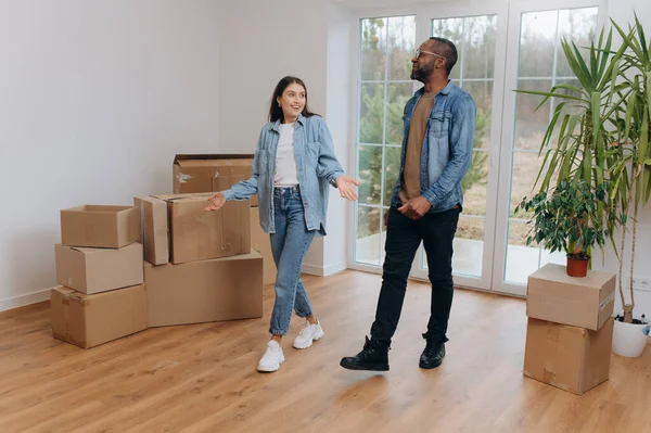 A young couple moves into a new house. an African-American man and his wife inside their new home