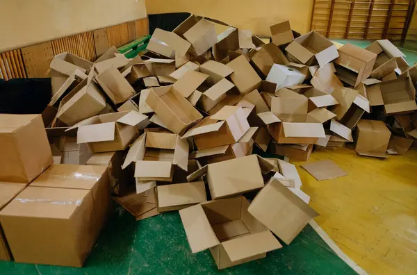 The storage room area is filled with empty cardboard boxes. a large group of used cardboard boxes. warehouse with boxes