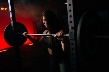 sporty woman squats in the gym. A sexy girl squats in the gym, shakes her ass. place for text