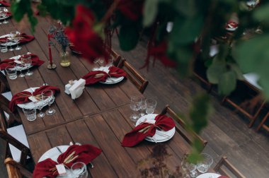 Beautiful table setting with plates, glasses on a wooden table