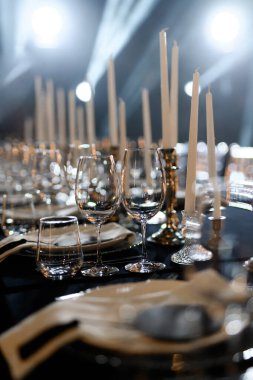 Cam eşyalar ve mumlarla dolu lüks bir yemek masası. Resmi etkinlikler ya da düğün resepsiyonları için mükemmel..