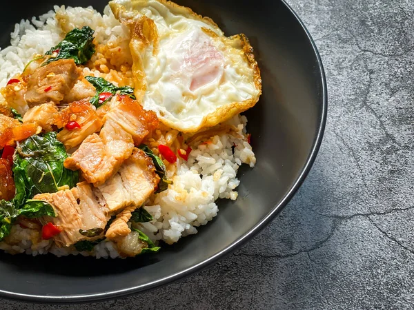 Rice topped with crispy pork belly with Thai basil and fried egg
