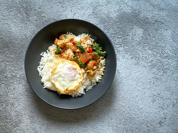 Rice topped with crispy pork belly with Thai basil and fried egg
