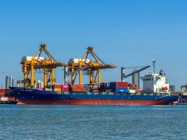 Bangkok Thailand - 30 Nov 2024:  The biggest port in Bangkok with loaded freight ship and cargo handling equipment on the side of Chao Phraya river clipart