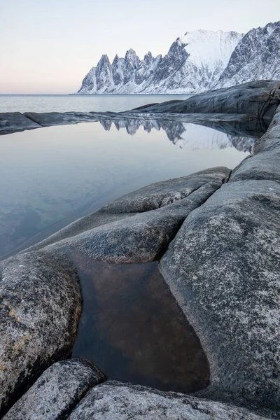 Scenery of Majestic snow mountain and calm sea at Senja Island, Norway Devil\'s Teeth mountains, Tungeneset, Okshornan, Senja, Norway