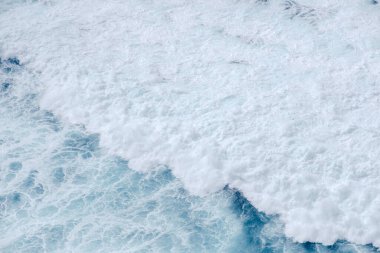 Huge crushing waves seen from above creating amazing textures.