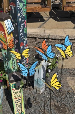 Sugar Land, Texas, USA - March 6, 2023: Bright garden decorations in the form of blue and yellow butterflies clipart