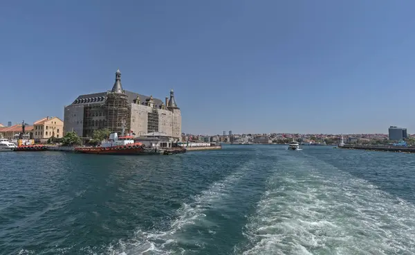 stock image Istanbul, Turkey - July 19, 2023: Haydarpasa railway station building under restoration. Stands on an embankment over the Bosphorus strait. View from the ferry.