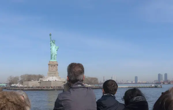 stock image New York Harbor, USA - March 15, 2024: The Statue of Liberty is visible on the Liberty island. View from the ferry. People are sailing to see one of the main attractions of the USA