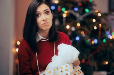 Woman Unhappy with her Lousy Christmas Gift clipart