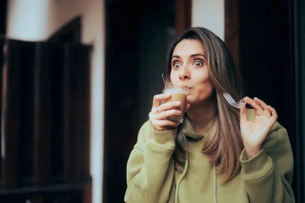 Woman Taking of her Invisible Retainer to Have a Coffee Drink