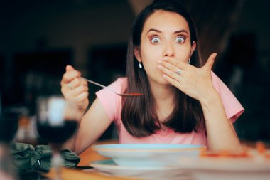 Sick Woman Eating Soup in a Restaurant Feeling Nauseated  clipart