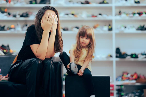 Stressed Mom Going Shopping for Shoes with her Daughter