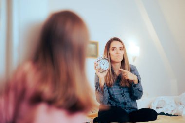 Mother Showing Her Hyperactive Daughter it is Past Bedtime 