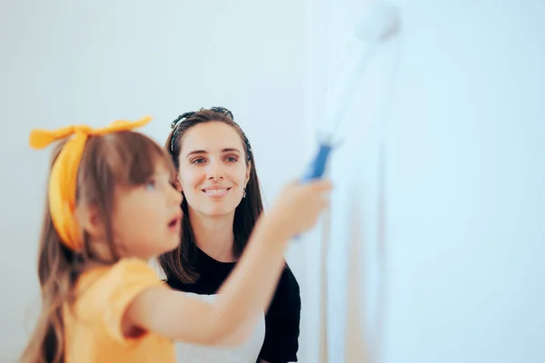 Mother and Daughter Painting a Room Ready for Spring Cleaning