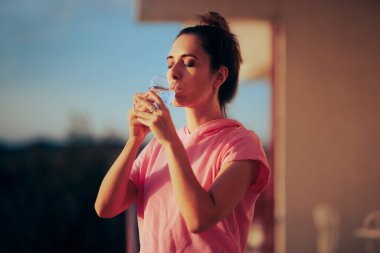 Beautiful Woman Having a Glass of Water in the Morning