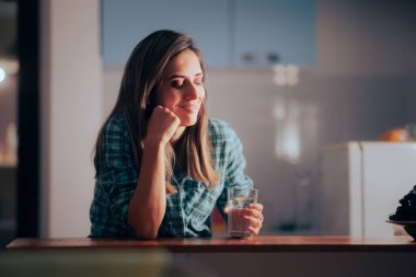 Woman Waking up During Nighttime to Drink a Glass of Water
