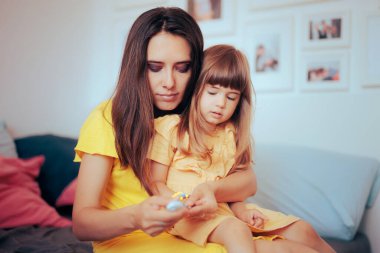Mother Trimming the Nails of her little Girl at Home