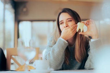 Woman having Dental Sensitivity Suffering from a Toothache 