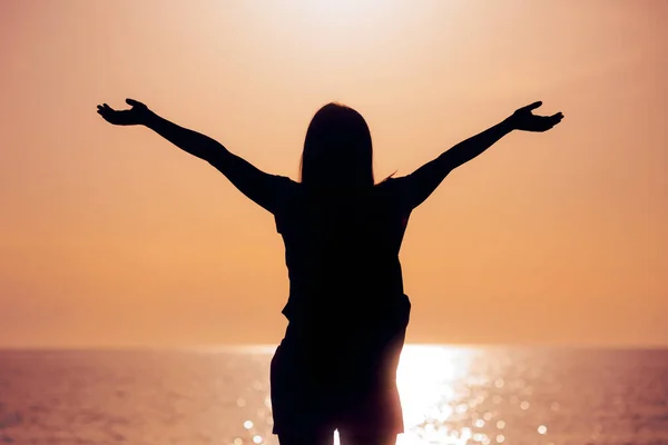 Silhouette of a Woman With her Arms Outstretched in Sunset View