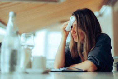 Woman Wiping Sweaty Forehead Using a Napkin  clipart