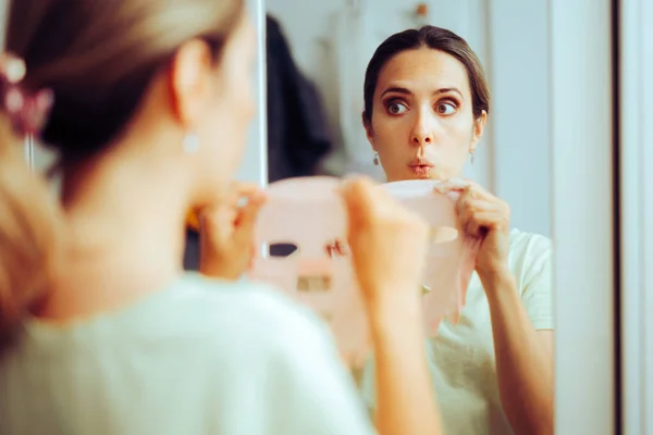 Happy Woman Using Sheet Mask Looking Mirror — Stock Photo, Image