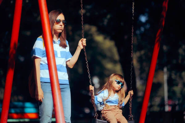 Tired Mom and Kid Feeling Bored at the Playground