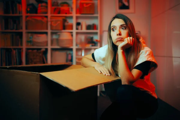 Unhappy Woman Unboxing a Big Delivery Box Thinking about Return