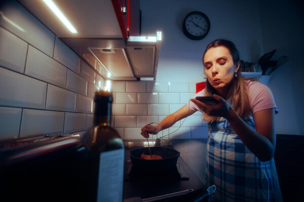 Pregnant Woman Using a Cooking Thermometer while Preparing Meat