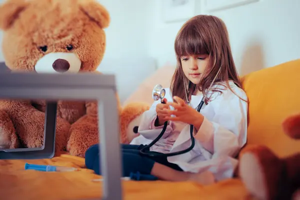 Little Girl Playing Doctor with a Teddy Bear