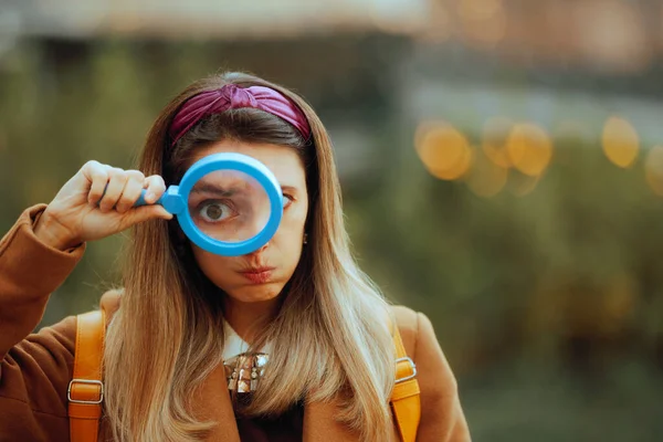 Funny Curious Woman Looking Through a Magnifying Glass