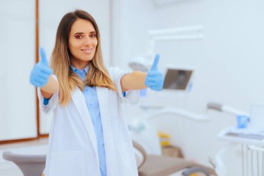 Happy Dentist Holding Thumbs up Feeling Optimistic clipart