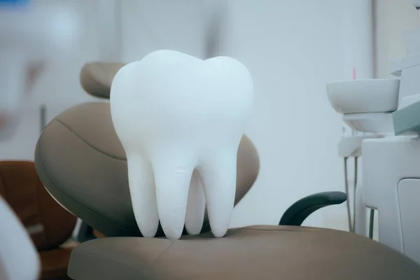 Big Tooth Sitting on a Dentist Chair in a Dental Office
