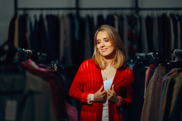 Happy Client Trying on a Red Sweater in a Fashion Store