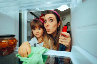 Mother and Daughter Cleaning the Refrigerator  clipart