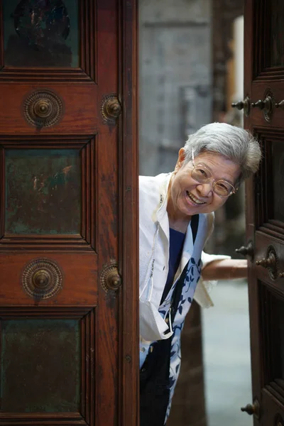 stock image asian old elderly elder senior woman smiling at door