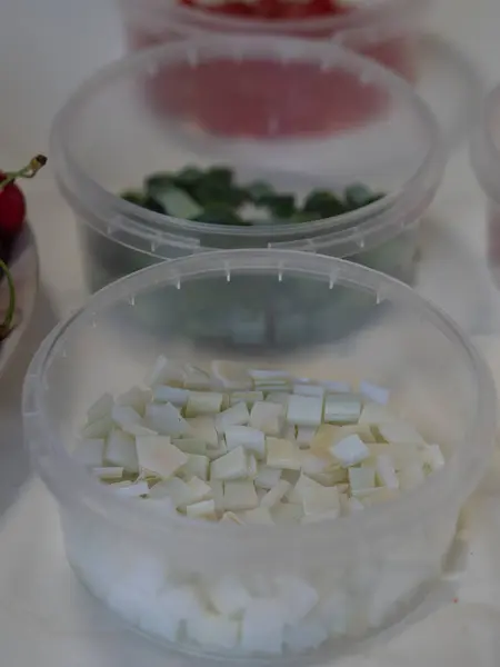 stock image Vertical close up shot of white, green and red vitrage glass pieces in plastic containers.