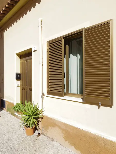 stock image Vertical Shot of an Italian House Entrance in Olbia, Sardinia with Yucca Plant and Pebbled Ground