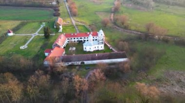 Aerial drone view of Bezdin Monastery in Arad County, Romania, Europe. Bezdin Monastery is one of the few remaining Serbian Orthodox monasteries in Romania, constructed in 1539 AD.