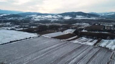 Drone flight above a frozen field, near Hateg town, Romania, Europe.