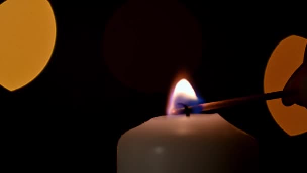 Close Woman Hand Lighting Candle Backdrop Christmas Lights — Stock Video