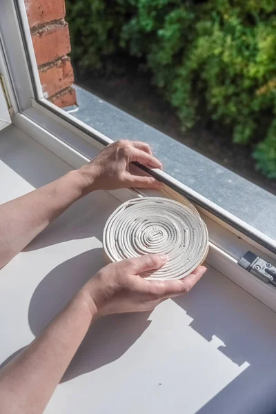 Preparing Cold Season Woman Sticks Dark Rubber Sealing Tape Window — Stock Photo, Image