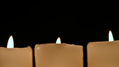 Siyah arka planda yanan mumlar var. Noel kutlaması. Anma Günü