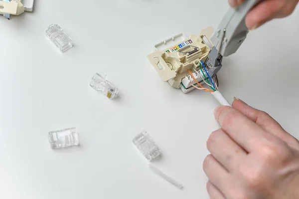 installing a wall ethernet socket. Connecting wires to an socket.
