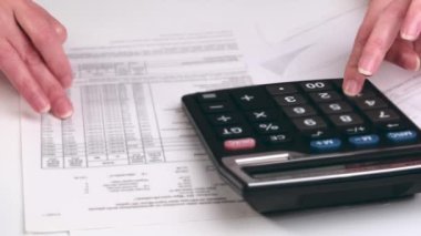 accountant working pointing graph discussion and analysis data charts and graphs and using a calculator