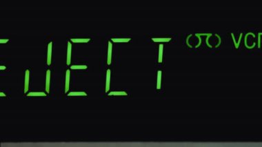 Close-up of a VCR display with a timer, VCR. Ejecting a cassette from a VCR.