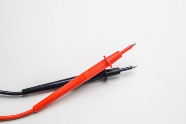 Multicolored multimeter probes top view isolated on white background. Electric probe.