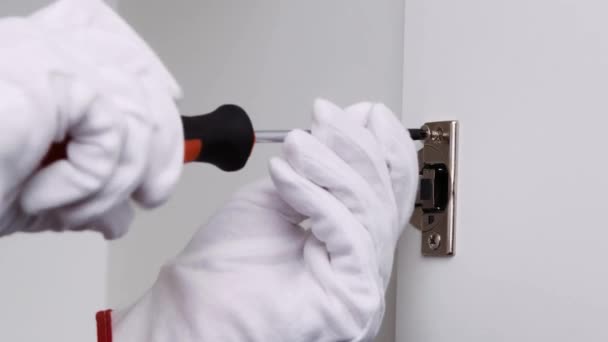 Man White Gloves Screwing Furniture Door Hinge Screwdriver — Stock Video