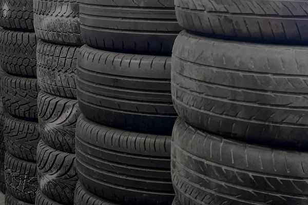 Tire stacks. Tires for sale in a tire store - stacks of old and new used tires.