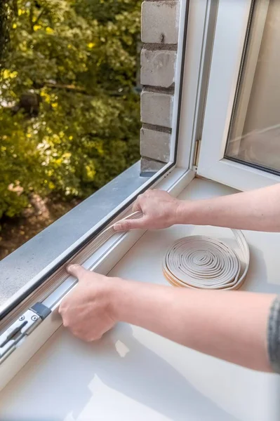 Man Puts Sealing Foam Window Room Keep Warm Concept Energy — Stock Photo, Image